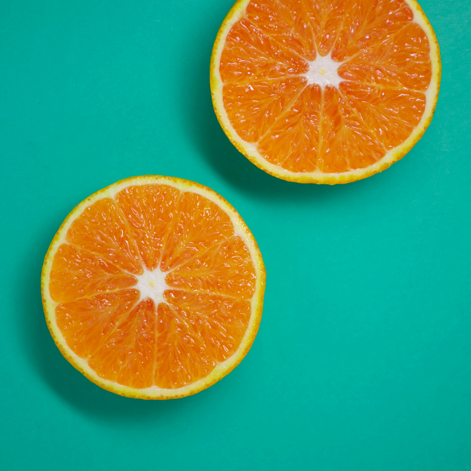 Sliced oranges on a blue surface